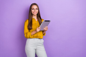 Portrait of cheerful pretty lady hands hold use tablet toothy smile isolated on purple color background