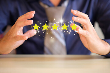 To complete five stars, place the customer's or client's hand on the stars. with additional copy space granting a five-star rating Service rating, concept of satisfaction