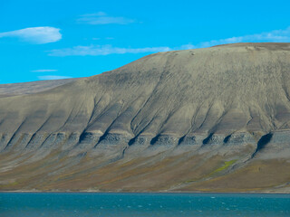 Panoramic view of mountainous snowless arctic landscape. Seen on Barentsoya island. Svalbard,...