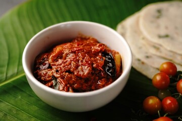 Homemade Tomato pickle Thokku or Chutney served with rice dosa- South Indian breakfast