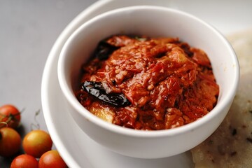 Homemade Tomato pickle Thokku or Chutney served with rice dosa- South Indian breakfast