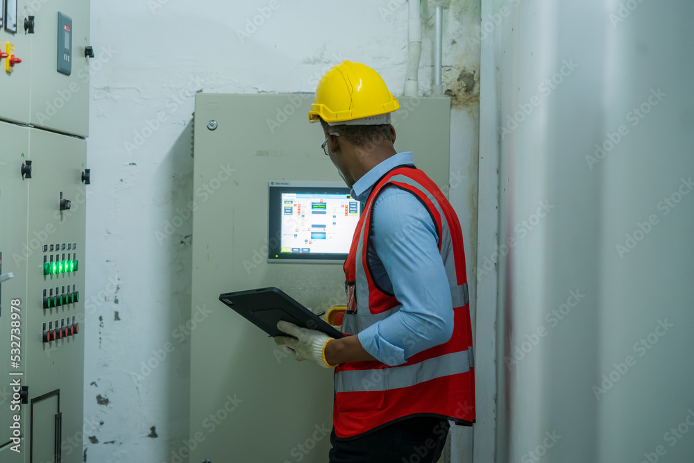 Aufkleber engineer working in electrical control room,operator station network in industry factory,switchgear.