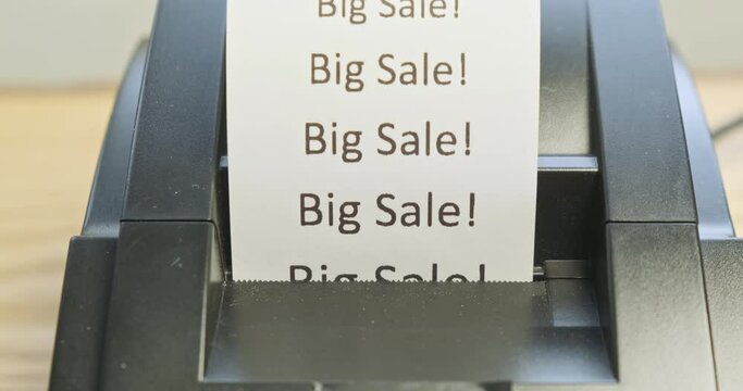 Receipt printer prints text: big sale. Close-up, front view. The concept of promotions, sales in stores.