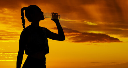 Shadow, sunset and silhouette woman drinking water for marathon running, fitness exercise and...