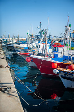 Photo ports with boats of fishermen at sea.