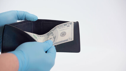 cropped view of person in latex gloves holding dollar banknote and wallet on white.
