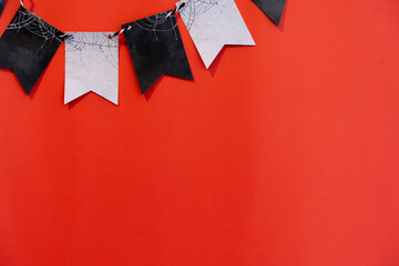 close up retro papers of bunting flags on dark orange color background for halloween festival...