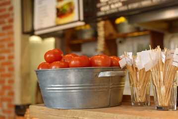 Tomatoes in a plate on a restaurant counter