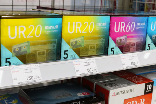 CHIBA, JAPAN - February 25, 2021: Cassette tapes on a shelf in a consumer electronics store. Below them are CD-R discs.