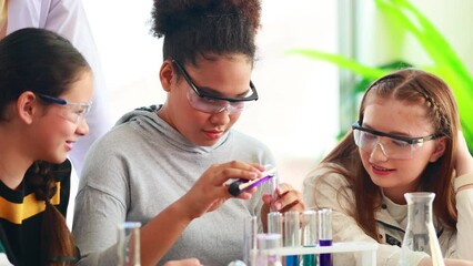 science experiment. African american and diversity teenage students caring out experiments in chemistry class - Powered by Adobe