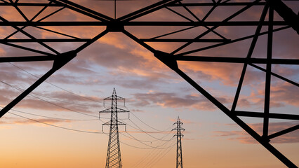 high voltage towers pylon on sunset background