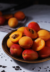 Fresh ripe apricots in bowl in rustic style	