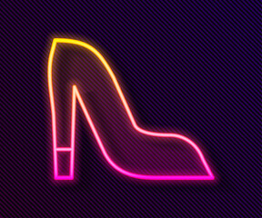 Glowing neon line Woman shoe with high heel icon isolated on black background. Vector