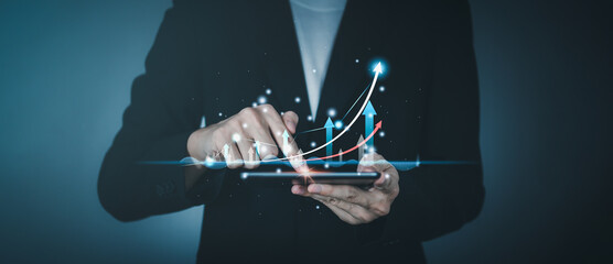 Success business concept. Businessman hand holding tablet with hologram of statistics graph and...