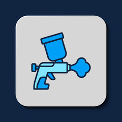 Filled outline Paint spray gun icon isolated on blue background. Vector