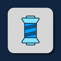 Filled outline Sewing thread on spool icon isolated on blue background. Yarn spool. Thread bobbin. Vector