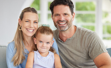 Fototapeta premium Happy portrait, family love and girl relax with mother and father on the living room sofa of house, smile for happiness in home and together in lounge. Face of parents with care for child on couch