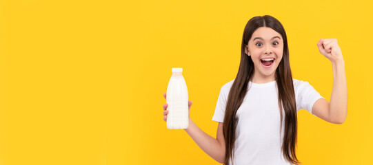 happy amazed child hold dairy beverage product. teen girl going to drink milk. Horizontal poster of...