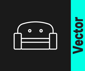 White line Armchair icon isolated on black background. Vector