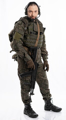 soldier in the studio on a white background. a man in military uniform with a rifle or machine gun. military or airball player