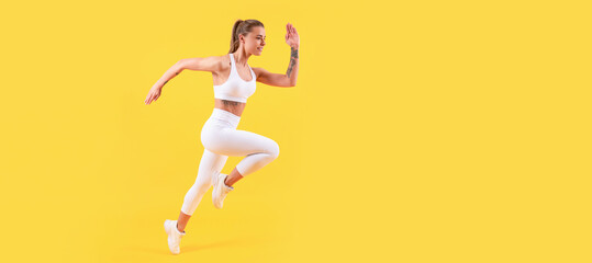 Fototapeta na wymiar fitness girl runner running in sportswear on yellow background. Woman jumping running banner with mock up copyspace.