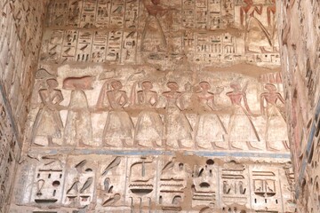 Pharaonic wall relief at temple of Ramses III (Medinet Habu) in Luxor, Egypt 