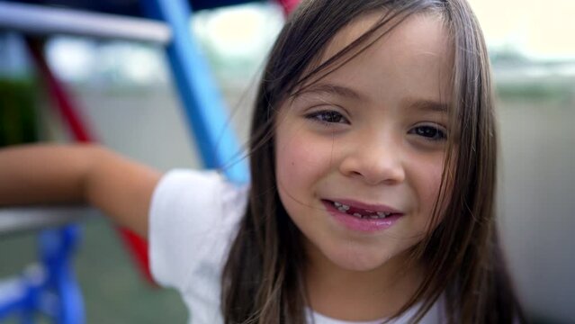 Portrait of little girl face smiling at camera child with missing teeth