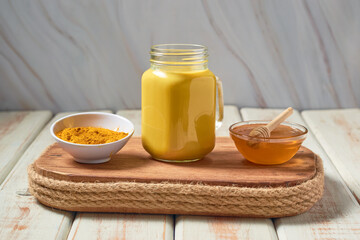 Traditional indian drink turmeric curcuma golden milk with ingredients