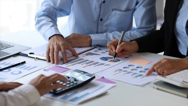 The sales department is having a monthly summary meeting to bring it to the department manager, they are verifying the correctness of the documents that are prepared before bringing in to the manager