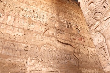 The Pharaoh at war: king Ramses III riding his war chariot (carvings at Medinet Habu temple in Luxor)