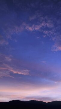 Twilight and dawn sky with cumulus cloud vertical time lapse in an evening.