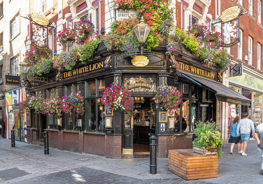 London, United Kingdom. Circa September 2022. Facade of a traditional english pub in Covent Garden in the heart of London's West End on a sunny day