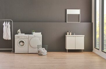 Washing and drier machine in the grey wall room background, laundry, clothe, sofa and working table style, minimalist home interior.