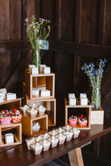 Candy bar. Festively decorated buffet table for guests. A stand with a variety of desserts for celebrating a party. Sweet buffet at a wedding party, birthday party.