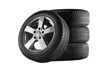 Car tires with a great profile in the car repair shop.  Set of summer or winter tyres in front of white fond. On transparent PNG background.