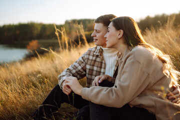 Happy couple in love walking in the park on a autumn day. Relaxation, youth, love, lifestyle concept.