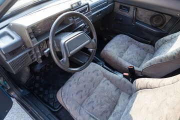 view through the reclined seat with a gray cloth and belt on the front panel of black plastic and...