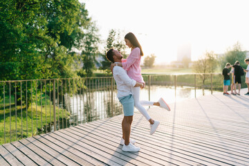 Happy diverse couple enjoying time together on embankment