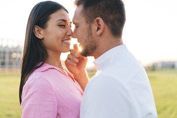 Happy young couple kissing in field