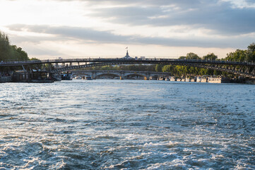 Bridges on river Seine, Paris, France. View from the boat, evening light.