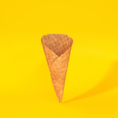 Waffle cone floating on a yellow background, 3d render