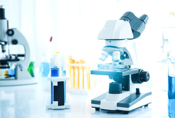 Medical science laboratory microscope and test tube analyze the test sample.