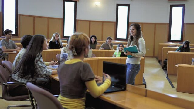 Young students listening a lesson inside university - School education concept