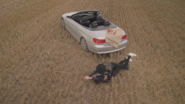the guy in the wheat field throws the girl on the ground