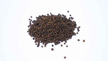 Pile of Organic Black pepper (Piper nigrum) isolated on white background. milled black pepper ,Black pepper corns. Black pepper grains as background close up