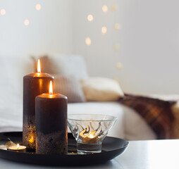 black and golden candles on white table