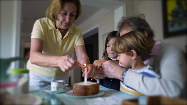 Family celebrating birthday with one candle. grandparents with grandchildren celebrate anniversary