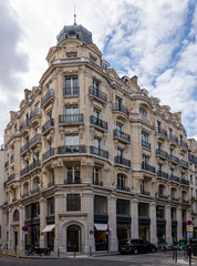 Fototapeta na wymiar Paris, France - 09 16 2022: View of an old facade of a corner building