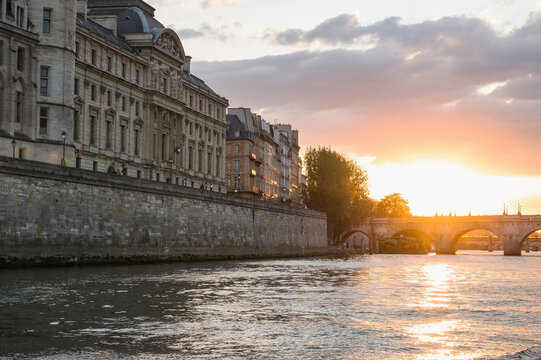 Sunset at Pont Neuf, the oldest standing bridge across river Seine in Paris, France with grotesk heads representing forest and field divinities from ancient mythology.