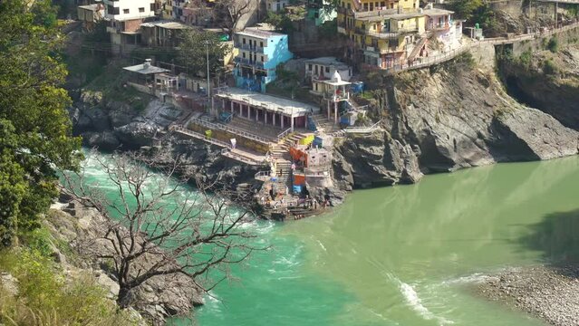Confluence of muddy colored Alakananda and green colored Bhagirathi river to form Ganges at Devprayag, Uttarakhand, India. This point is known as Sangam and people offers prayers at temple built here.
